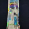 A tiny, colorful, vertical object on black.| Psilocybin Myco
